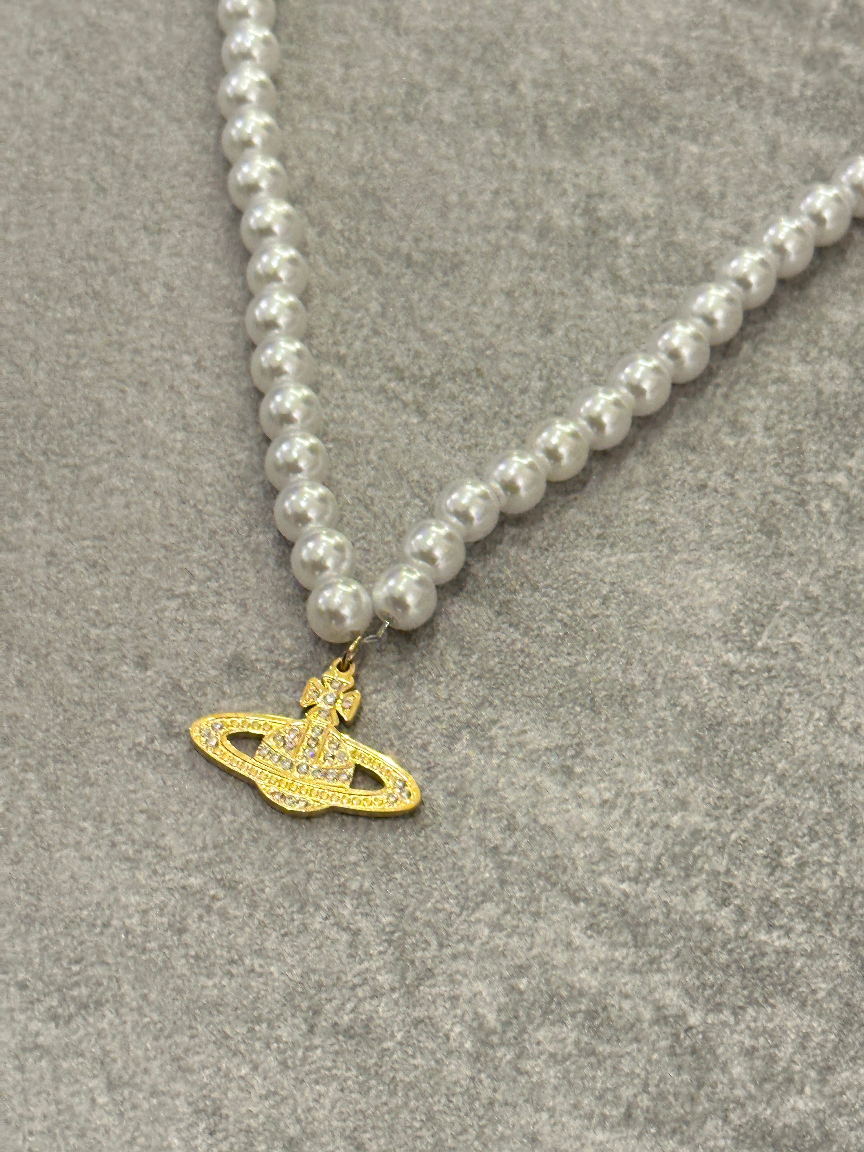 Pearl choker necklace with gold orb pendant inspired by Vivienne Westwood, perfect for vintage and Y2K fashion styles